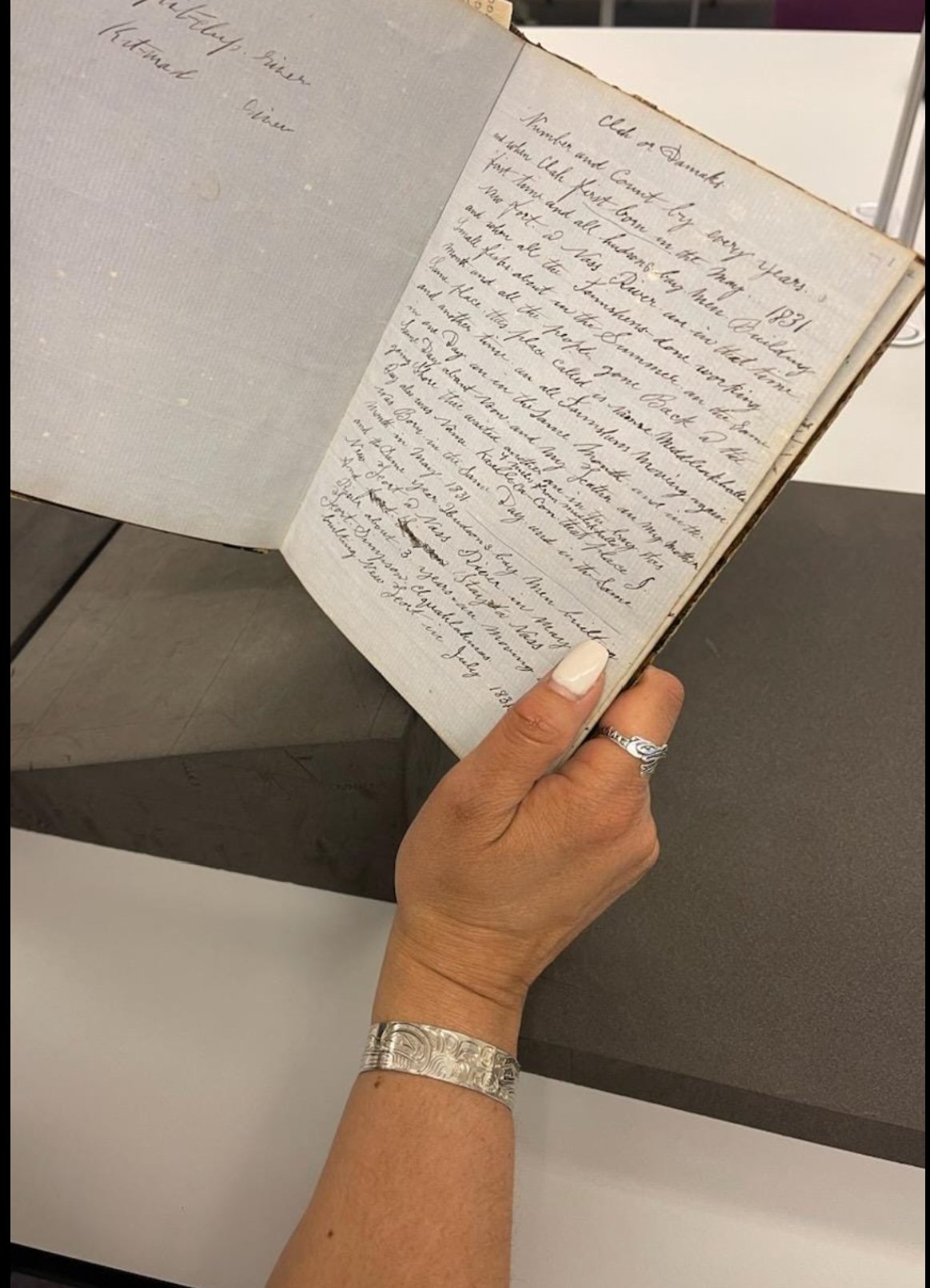 Tobi Iverson holding open pages of Arthur Wellington Clah's journal — Wellcome Collection, London